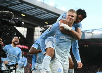 Manchester City players celebrate their 3–0 Premier League win against Liverpool at Anfield amid the club's financial verdict