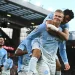 Manchester City players celebrate their 3–0 Premier League win against Liverpool at Anfield amid the club's financial verdict